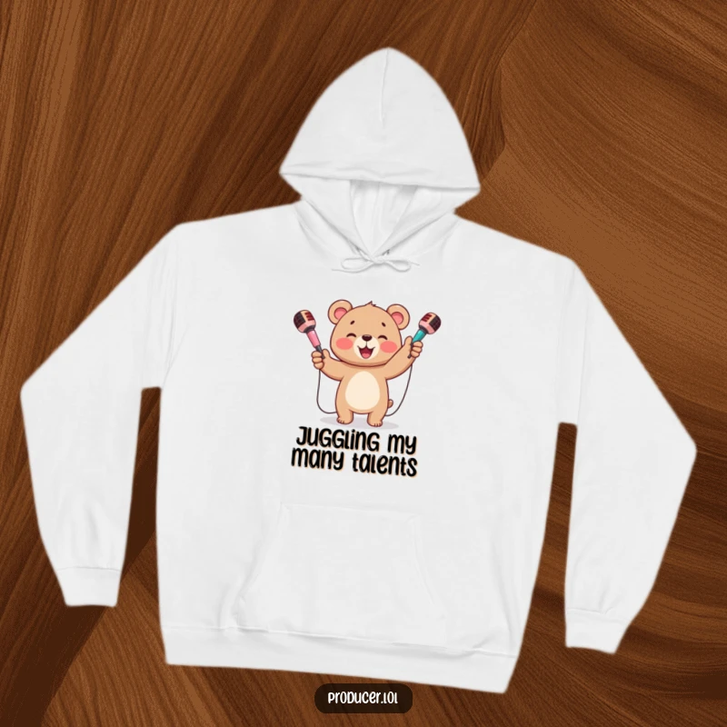 Funny hoodie featuring a happy bear cub beaming and juggling three colorful microphones with infectious enthusiasm.